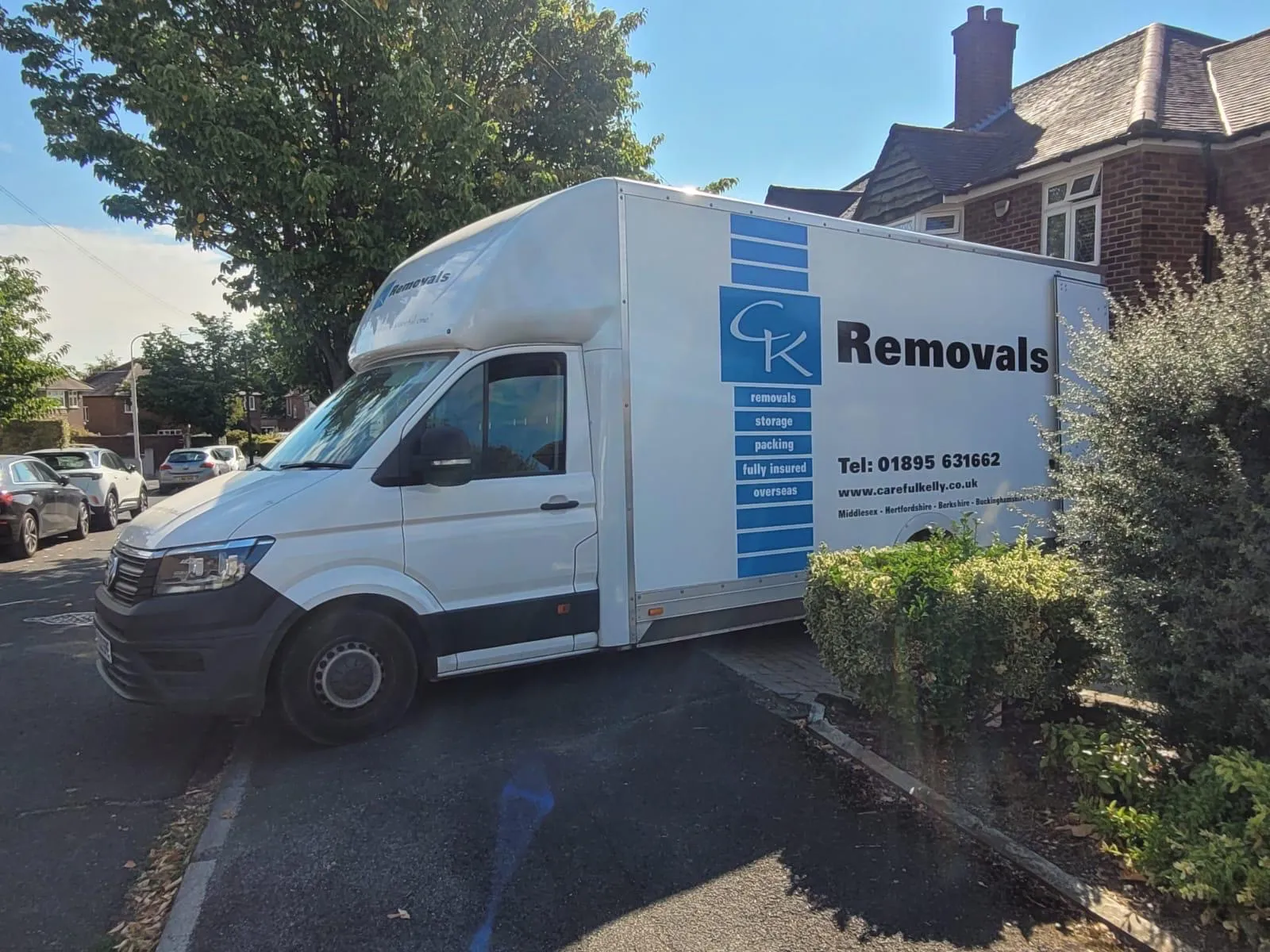 Careful Kelly Removals branded van parked on a residential driveway