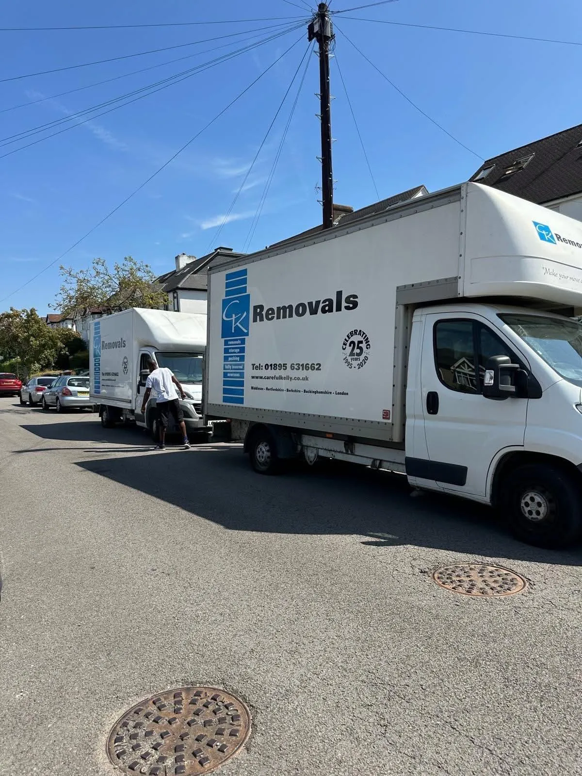 Careful Kelly Removals branded vans parked on a West London commercial job