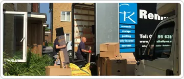 Careful Kelly Removals crew loading boxes into a branded removal van