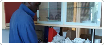 Careful Kelly Removals crew member packing kitchen items into a box